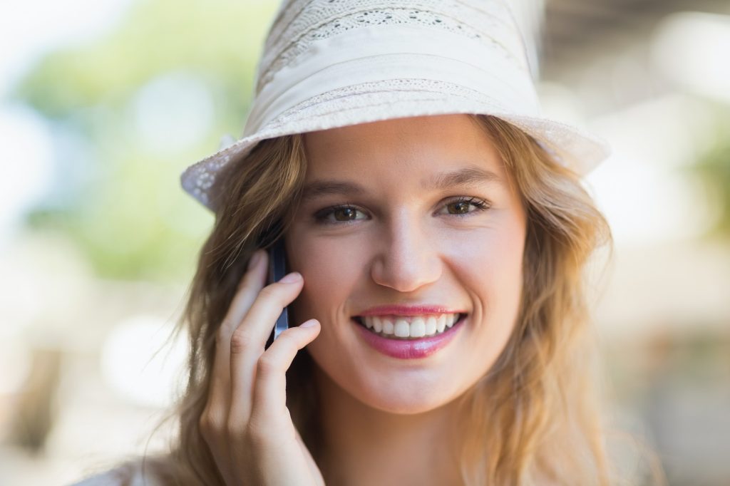 Portrait of a pretty smiling woman on the phone